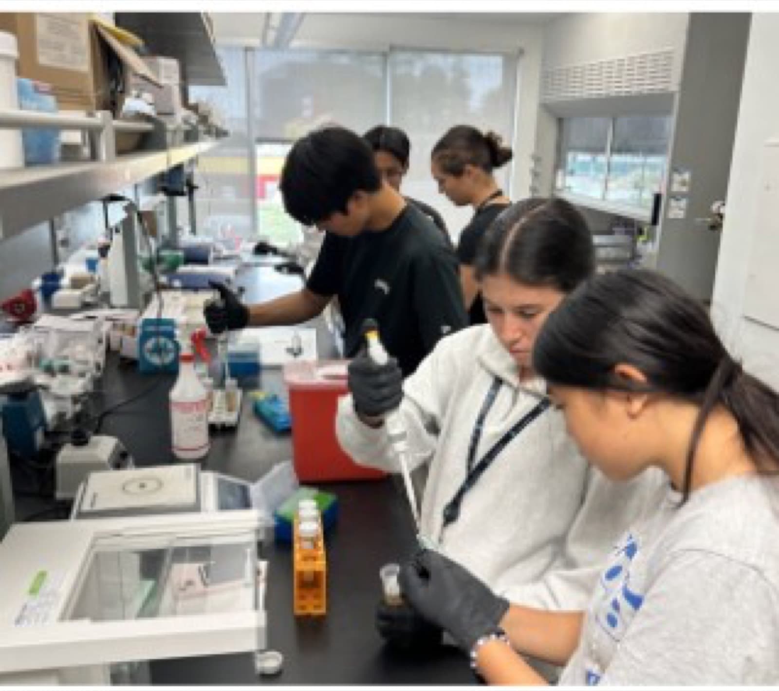 Abby exploring STEM through hands-on laboratory work with other students
